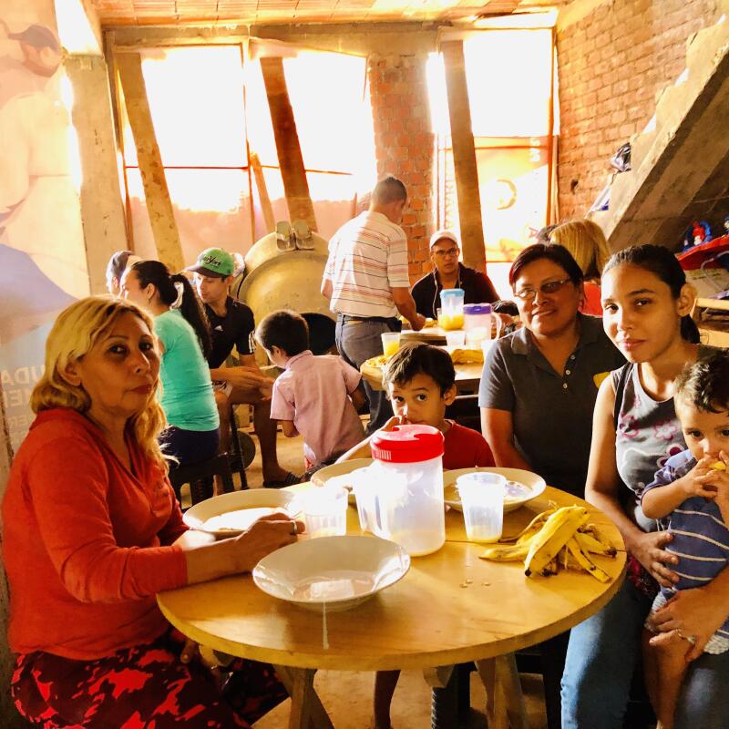 Beneficiaries enjoying a meal at the project