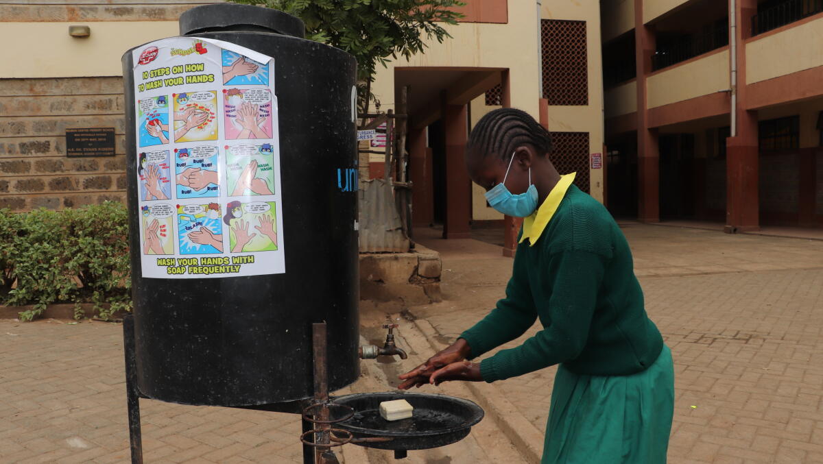 Ruben Primary Pupil at the Hand Washing Station at the Ruben Centre