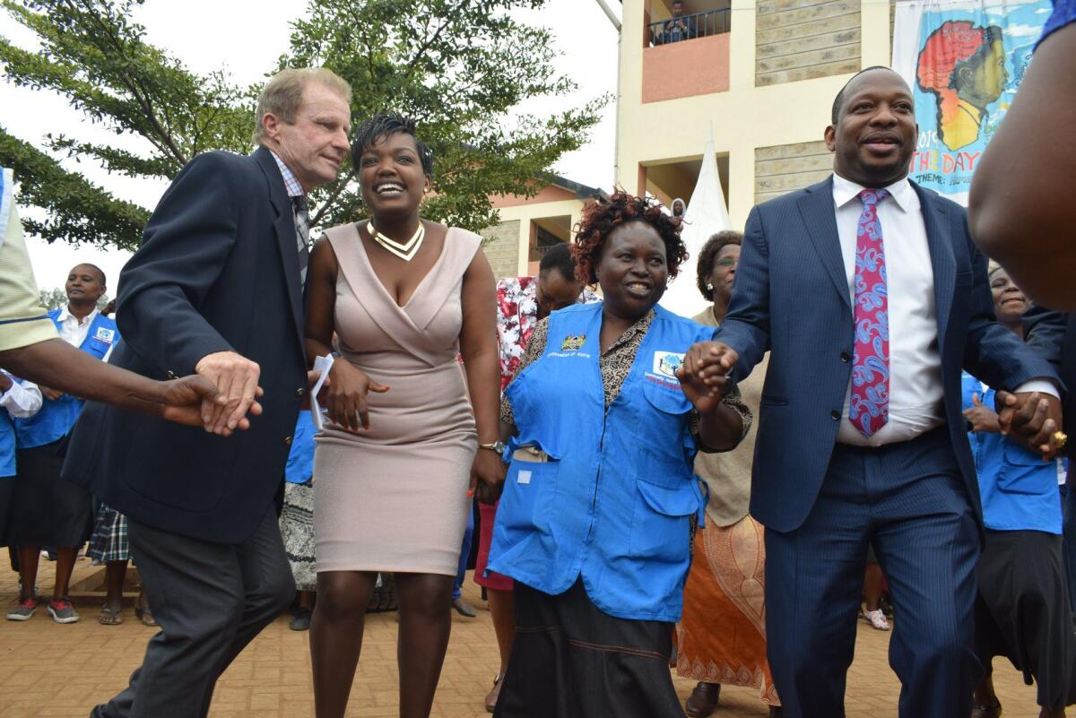 Br. Frank O'Shea, Zippora Mwangi, and His Excellency Mike Mbuvi Sonko with a Community Health Worker