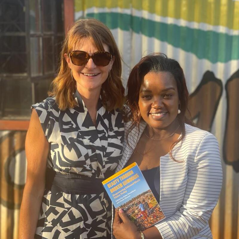 Fiona Dowling presenting the book to Ruben Centre Deputy Director Zipporah Mwangi