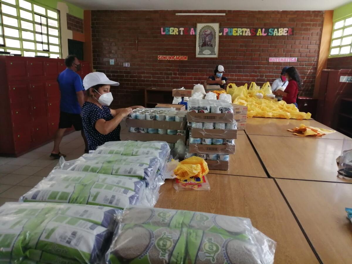 The delivery and distribution of food supplies to needy families at the Fe y Alegría project